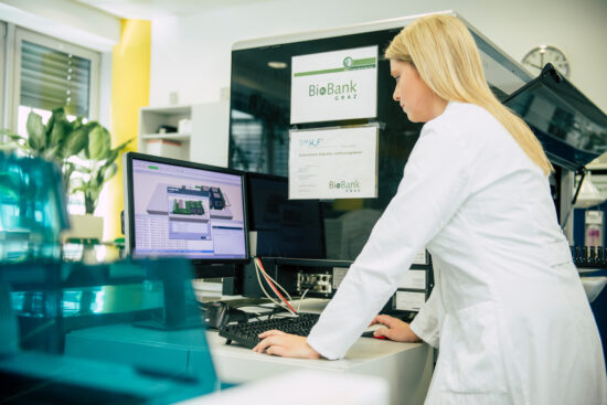 Scientist in a white coat working on a computer